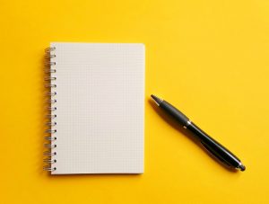 yellow image with pen and notepad